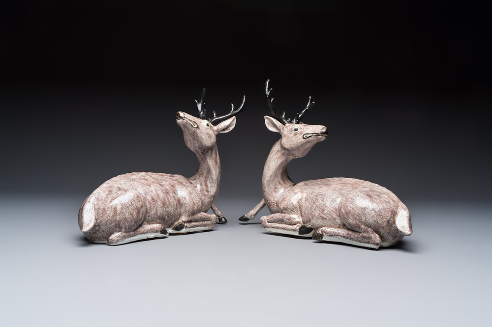 A pair of Chinese aubergine-glazed models of recumbent deer, 18/19th C.