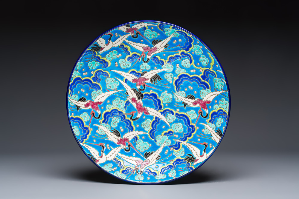 A French polychrome enamelled Longwy 'Cranes among Clouds' charger, 20th C.