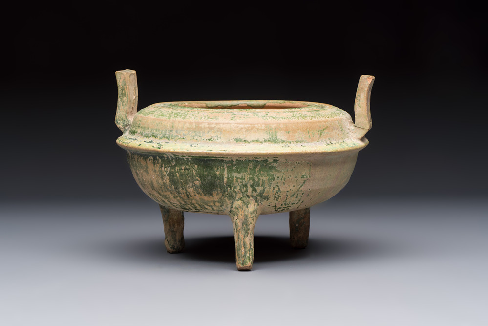 A Chinese green-glazed pottery ritual tripod food vessel with handles, 'Ding 鼎', Han