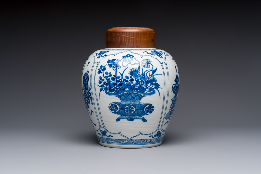 A Chinese blue and white 'Antiquities and Flower Baskets' vase with a wooden cover, Kangxi