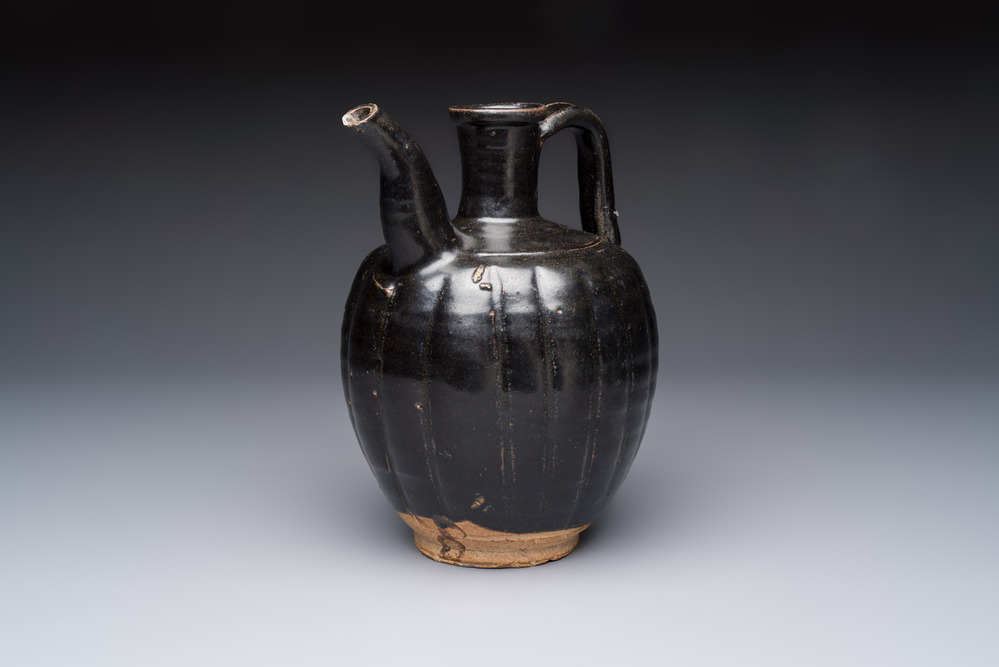 A Chinese Yaozhou black-glazed ewer with a ribbed body, Song