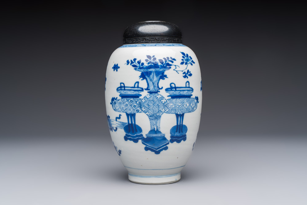 A Chinese blue and white ovoid 'Antiquities' jar with a wooden cover, Kangxi