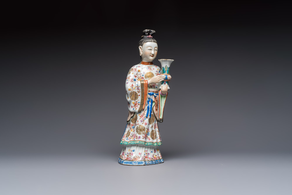 A Chinese famille rose candle holder in the shape of a court lady holding a 'Gu' vase, Qianlong