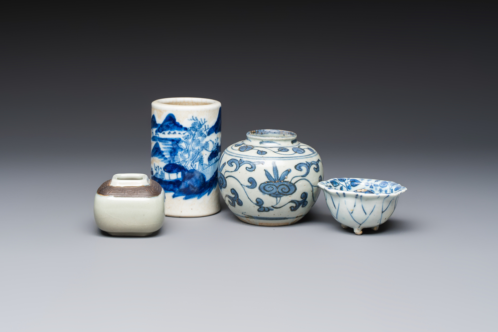 A Chinese Nanking water pot, a blue and white brush pot, a jarlet and a trick cup, Ming and later