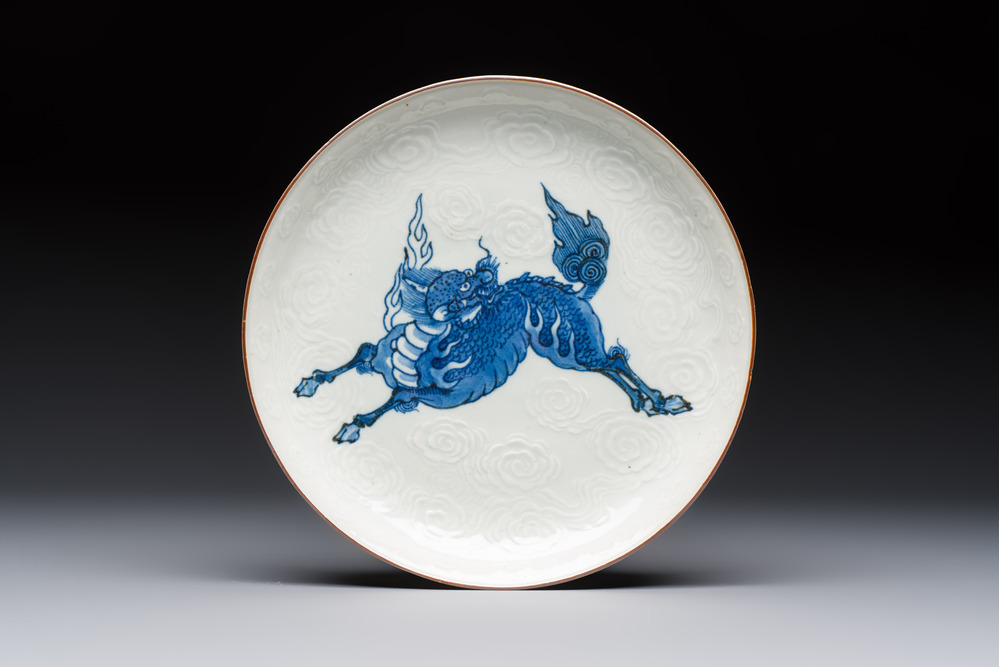 A Japanese Arita blue and white Kakiemon-style 'Kirin' plate with underglaze relief design, Edo, 18th C.