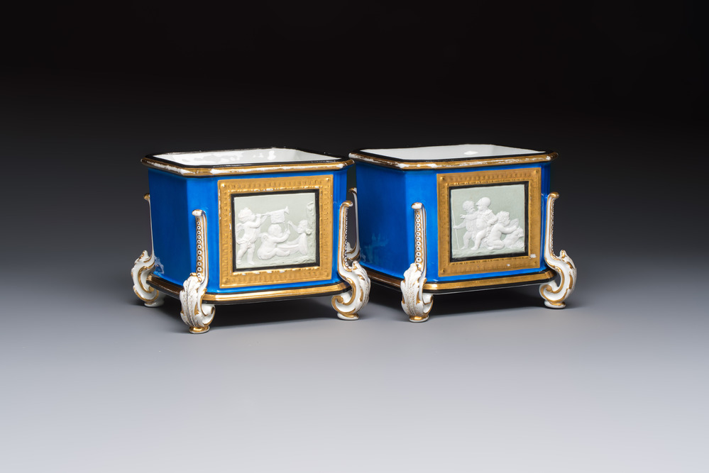 A pair of French gilt blue-ground 'Cherub' jardini&egrave;res with biscuit-relief plaques, 19/20th C.