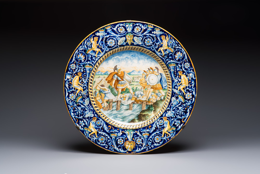 A massive polychrome Italian maiolica istoriato charger with a classical battle scene, 19th C.