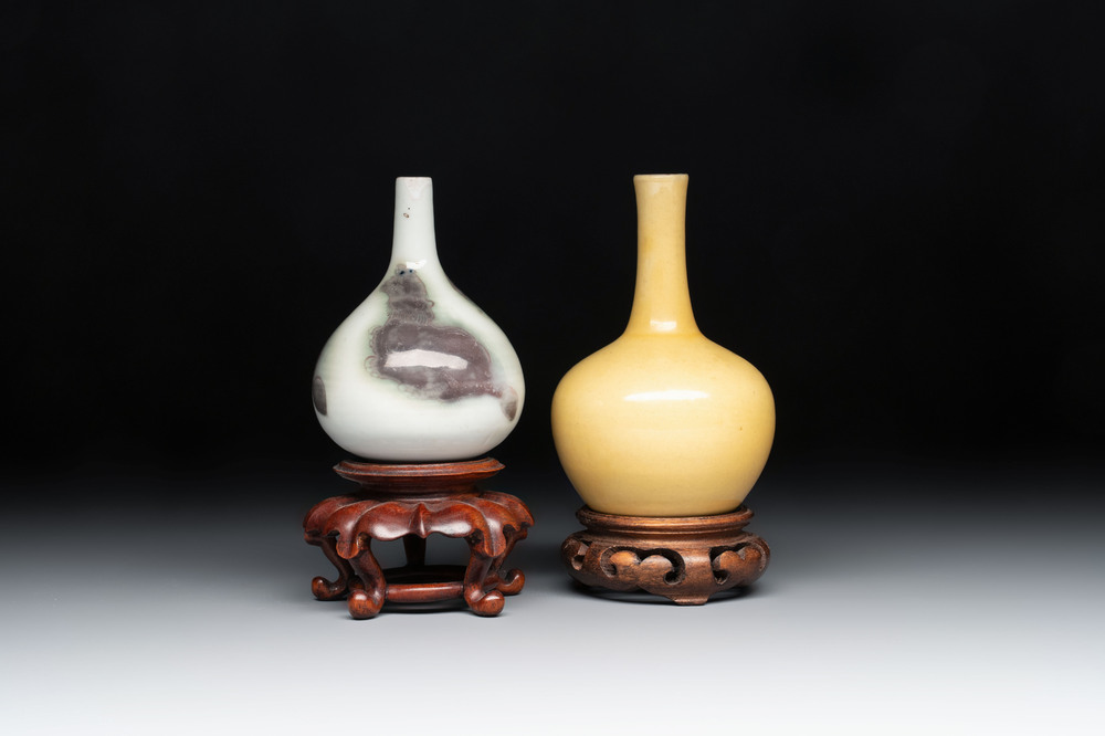 A Chinese copper-red and white 'Mythical Beasts' vase and a yellow-glazed bottle vase, on later wooden stands, Kangxi and later