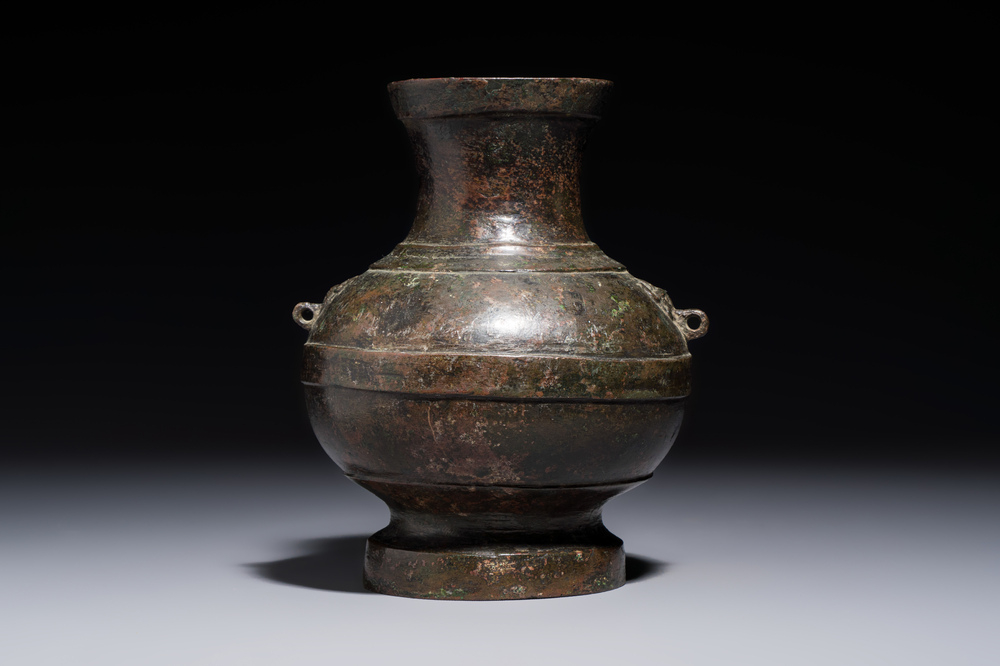 A miniature Chinese archaic bronze wine vessel with Taotie handles, 'Hu 壺', Han