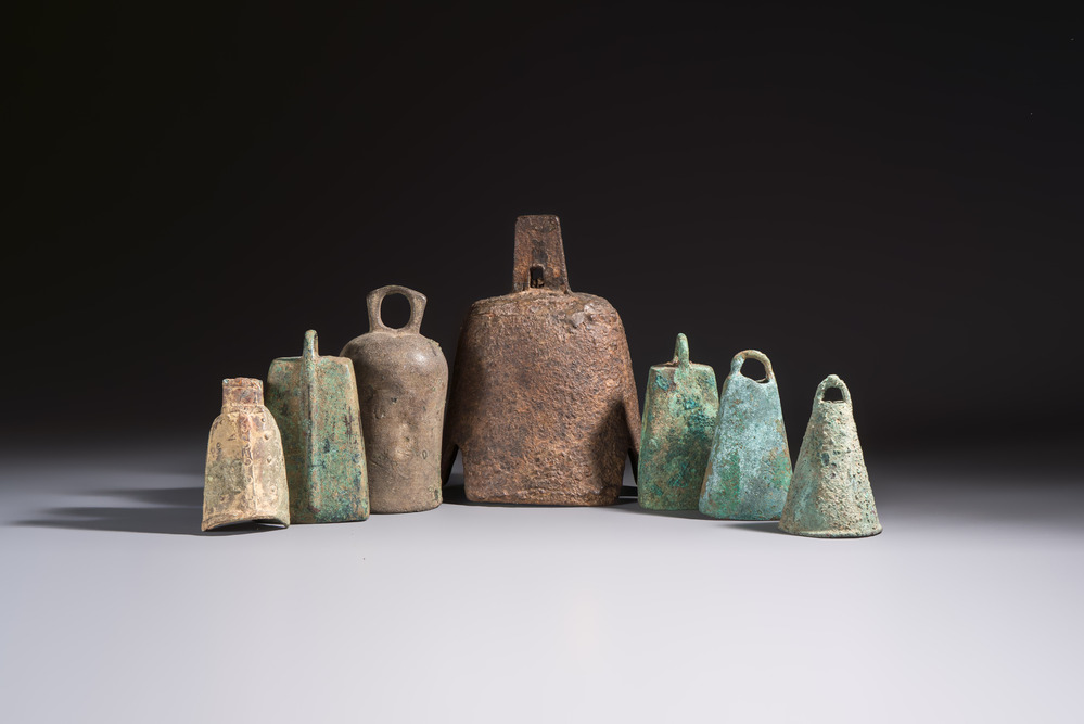 Seven various Chinese bronze and cast-iron bells, Han and later