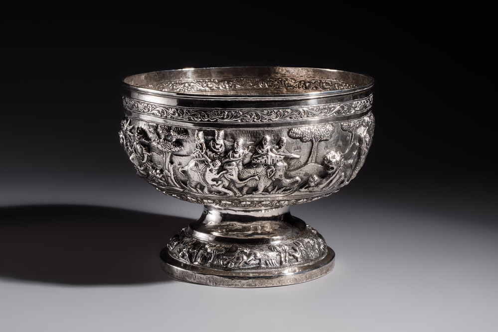 A large repouss&eacute; silver footed bowl depicting a hunting scene, India, late 19/early 20th C.