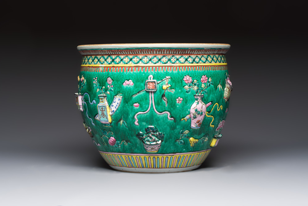 A Chinese famille rose green-ground 'Antiquities' fish bowl or jardini&egrave;re with applied relief design, 19th C.