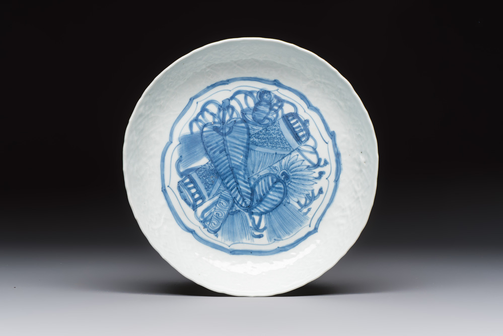 A Chinese blue and white plate with a relief-moulded rim, Wanli