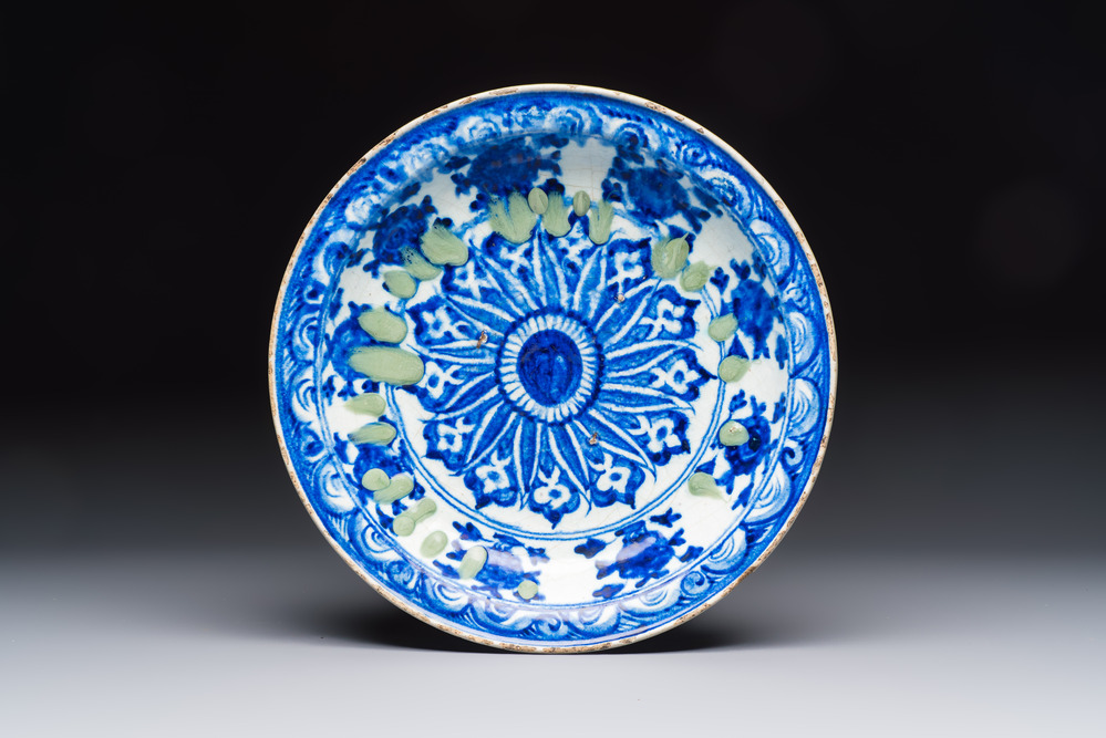 A Persian blue, white, and green glazed dish with stylised floral design, Safavid, 17/18th C.