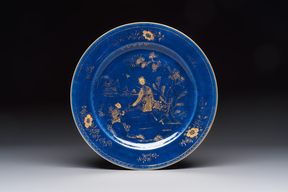 A Chinese gilt-decorated powder-blue-ground 'Elegant Beauty and Boy' dish, Kangxi
