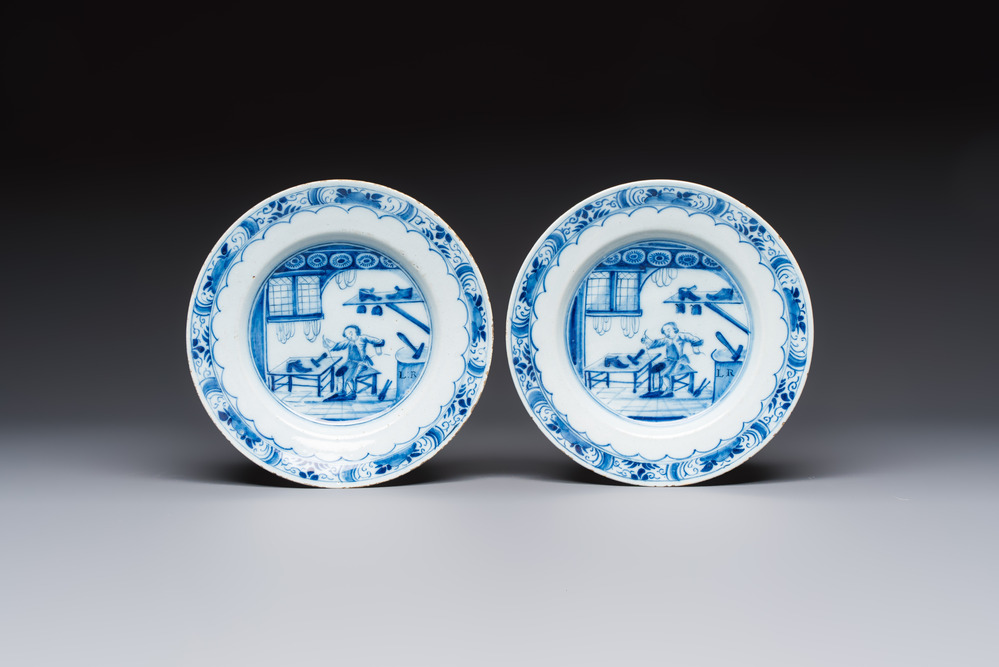 A pair of rare blue and white Dutch Delft 'Shoemaker' plates, 18th C.