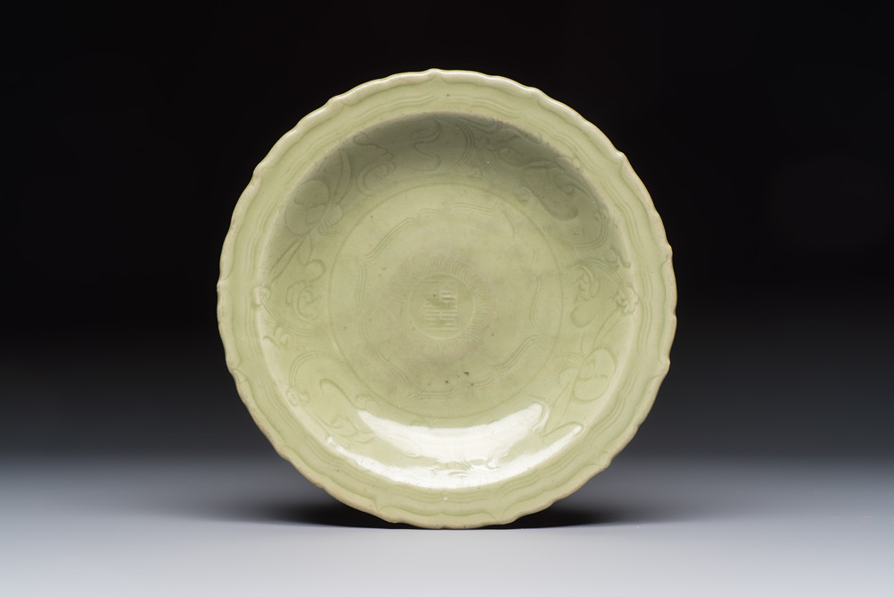 A Chinese Longquan celadon inscribed dish with incised floral design, Ming