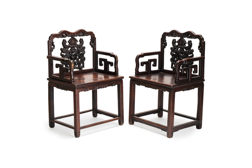 A pair of Chinese carved hongmu armchairs, 19th C.