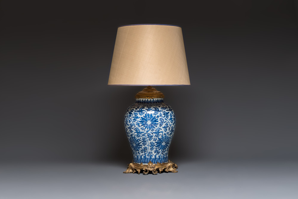 A large Chinese blue and white 'Lotus Scroll' baluster vase with later gilt-bronze lamp mounts, Kangxi