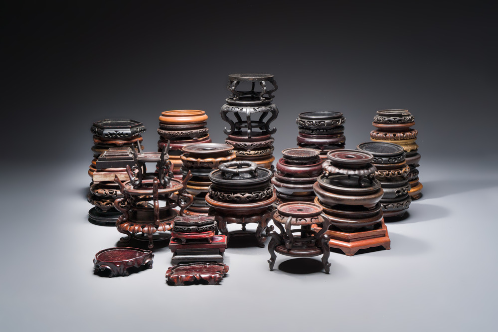 A collection of 70 Chinese wooden stands, 19/20th C.