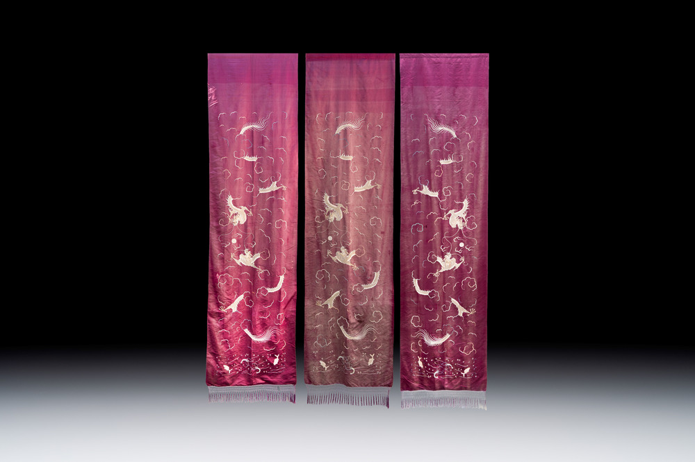 Three large Chinese purple-ground embroidered silk 'Dragons among Clouds' panels, 19th C.