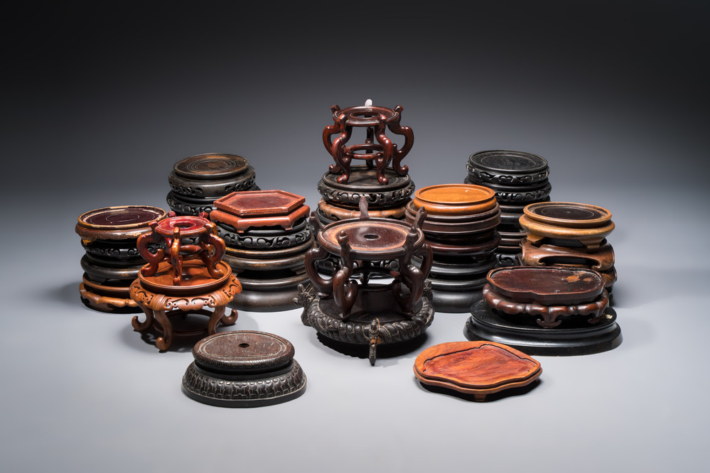 A collection of 40 mainly Chinese wooden stands, 19/20th C.
