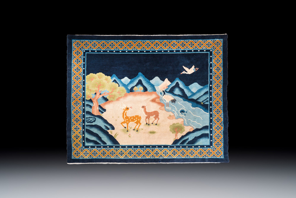 A Chinese woollen 'Cranes and Deer' carpet, 20th C.