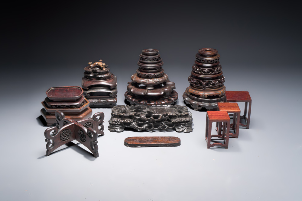 A collection of 25 Chinese wooden stands, 19/20th C.