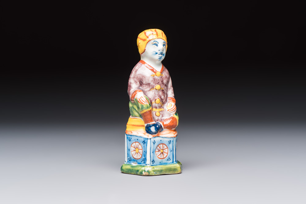 A polychrome Dutch Delft model of a seated oriental figure, 18th C.