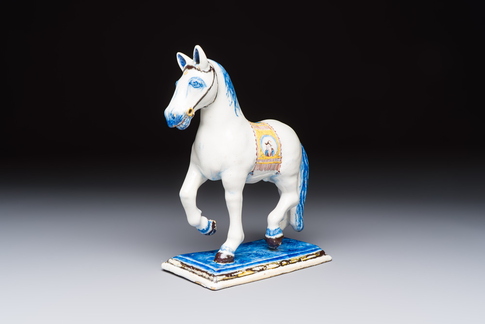 A polychrome Dutch Delft model of a standing horse with a figurative saddle cloth, 18th C.