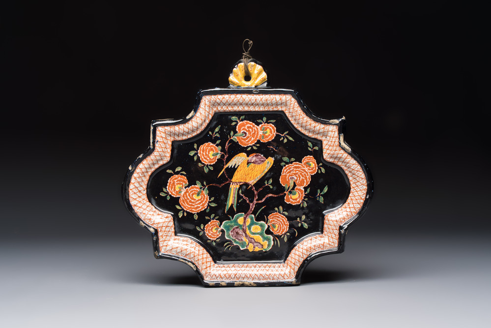 An exceedingly rare polychrome black-ground Dutch Delft plaque with a parrot, 18th C.