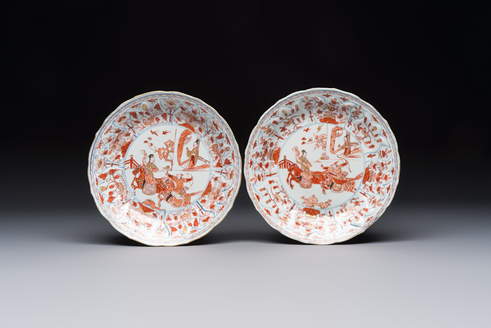 A pair of Chinese gilt iron-red-decorated 'Falconry' plates, Kangxi