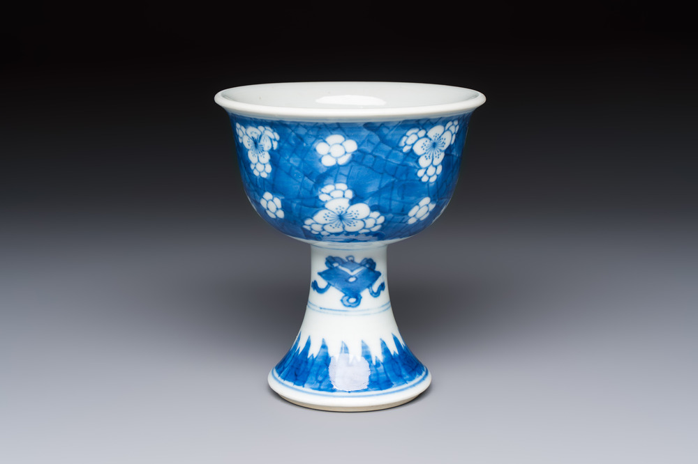 A Chinese blue and white 'Prunus on Cracked Ice' stem bowl, Kangxi