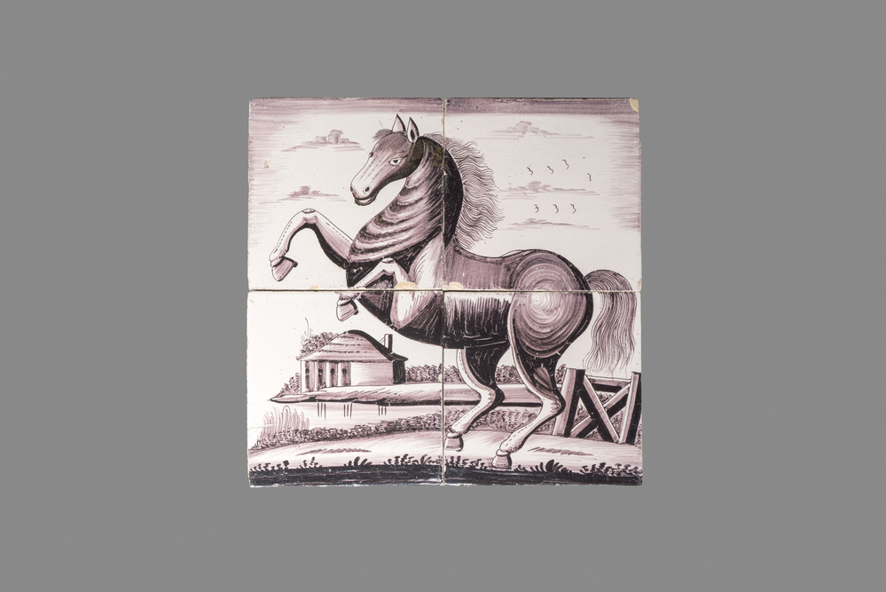 A manganese Dutch Delft four-tile panel with a rearing horse, 18th C.
