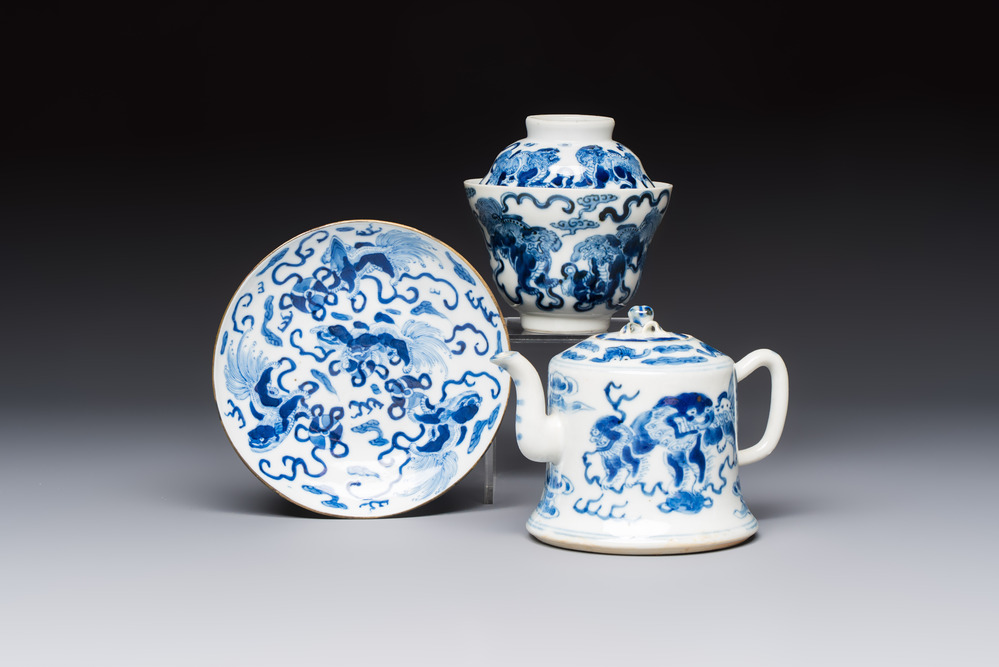 A Chinese blue and white 'Buddhist Lion' teapot, covered bowl and a saucer, various marks, 19th C.