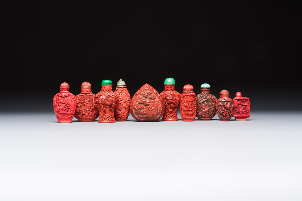 Nine Chinese cinnabar lacquer snuff bottles and a covered box, Qianlong marks, 19/20th C.