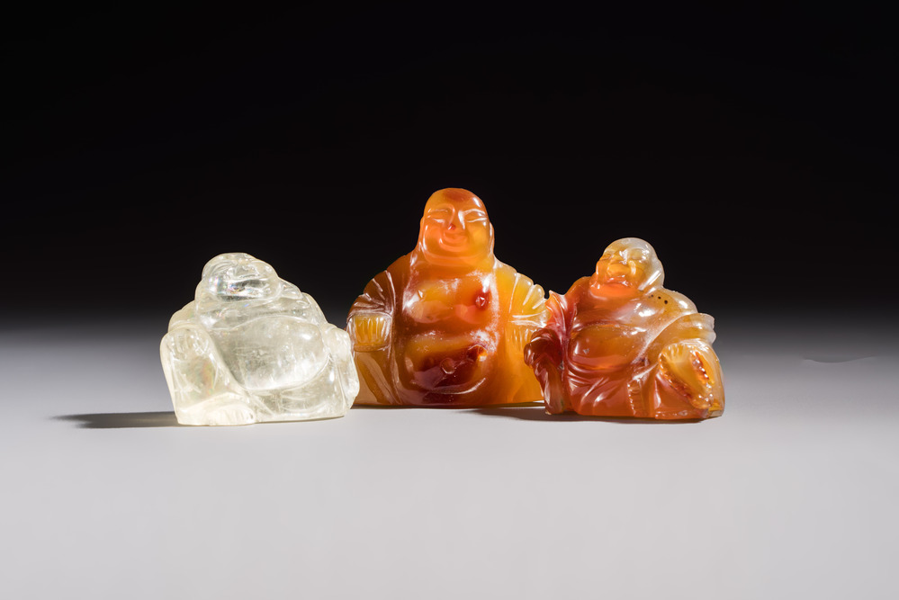 A Chinese carved rock crystal Milefo Buddha and two agate Milefo Buddhas, 19/20th C.