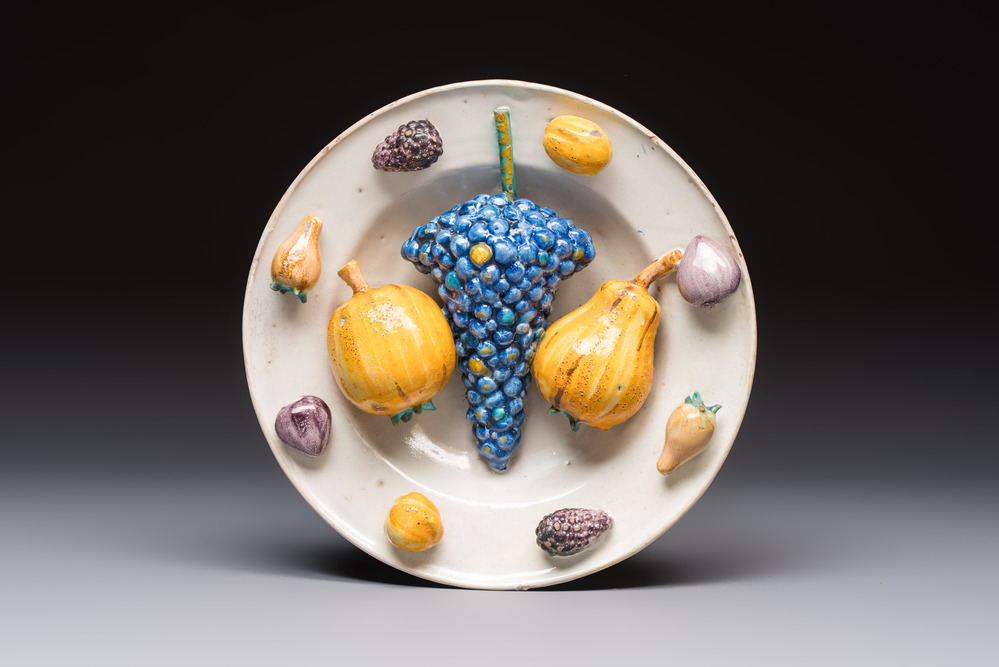 An unusual polychrome Swiss faience trompe l'oeil dish with various fruits, Winterthur, workshop of David Pfau II, 17th C.