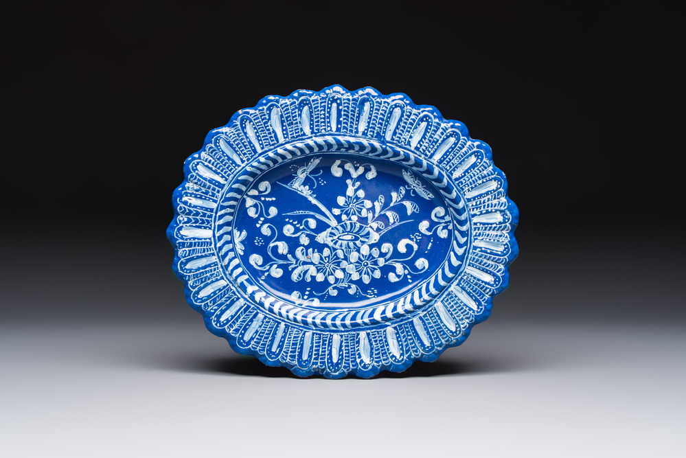 An oval French Persian-blue-ground white-decorated faience dish with butterflies and foliage, Nevers, 17th C.