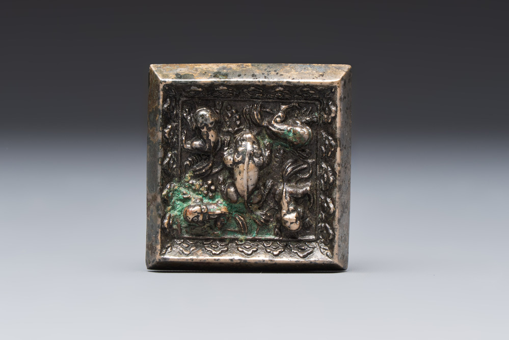 A small Chinese metal-alloy square mirror with relief design, Tang