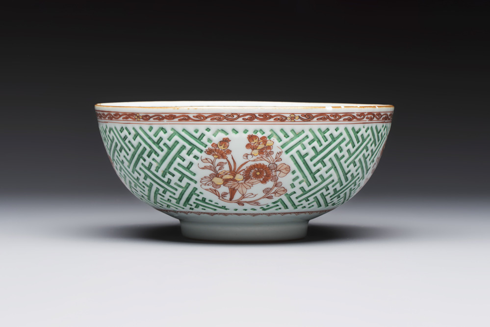 A Chinese famille verte relief-carved bowl with gilt iron-red floral design, Kangxi
