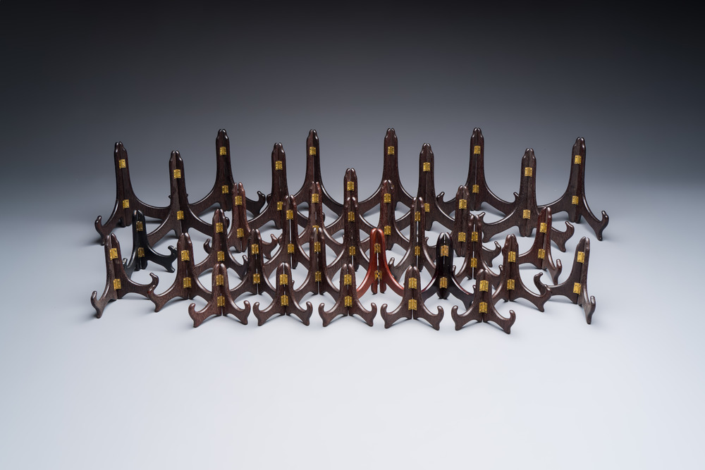 A collection of 35 Chinese folding wooden plate stands, 20th C.