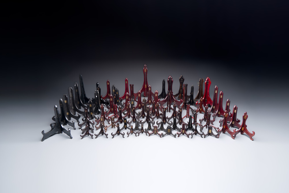 A collection of 75 Chinese folding wooden plate stands, 20th C.