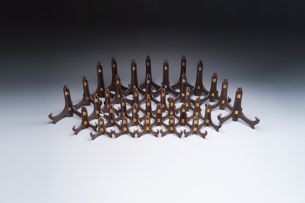 A collection of 35 Chinese wooden folding plate stands, 20th C.