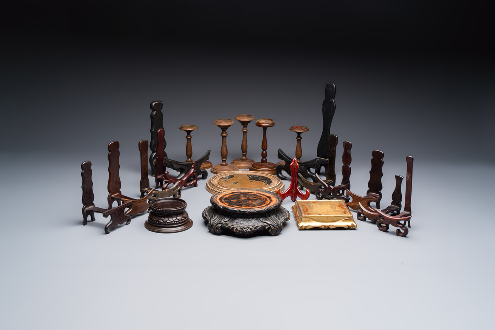 A collection of 21 wooden stands, 20th C.