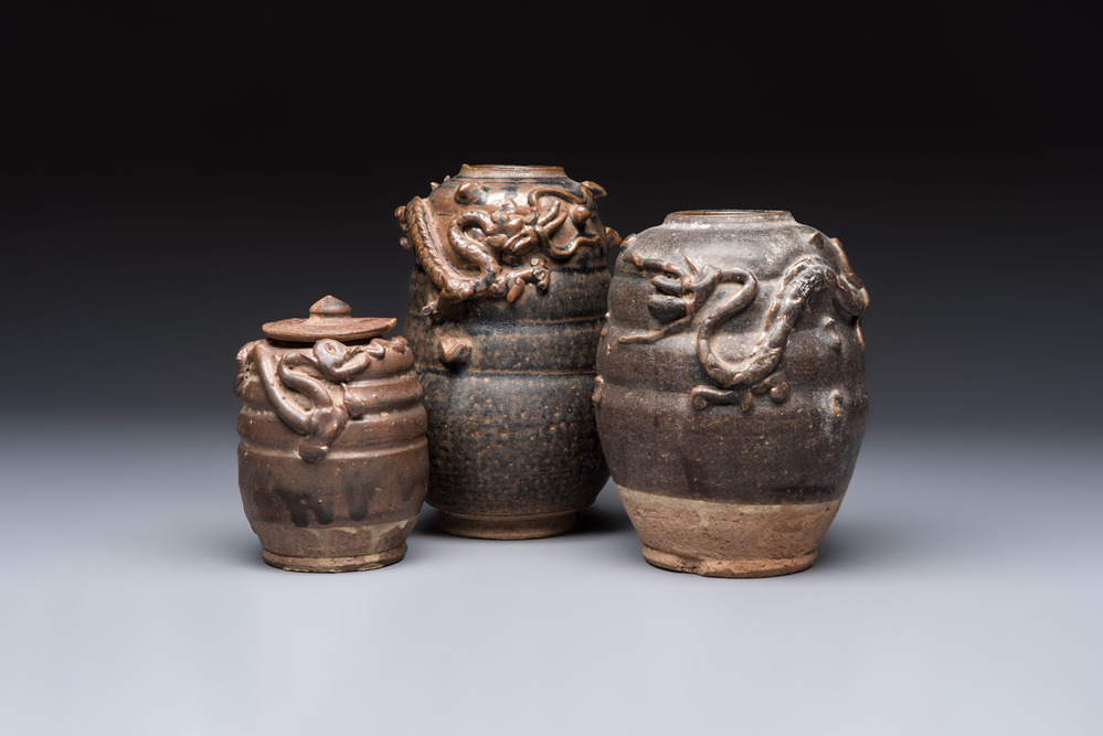 Three Chinese brown-glazed jars with an applied dragon design, one with cover, Song