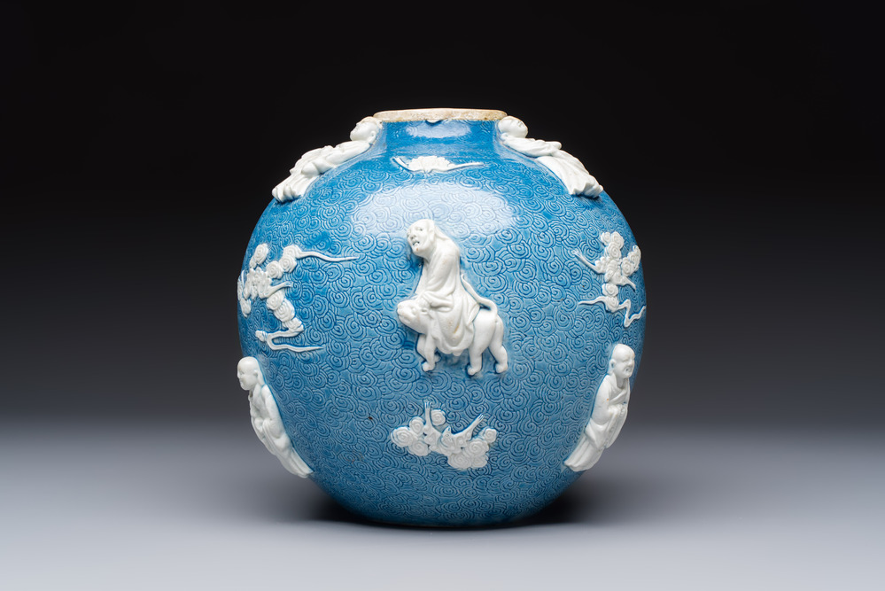A Chinese sgraffiato blue-ground 'Luohan' vase with relief design, 19th C.